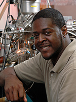 Graduate student sits in front of microscope